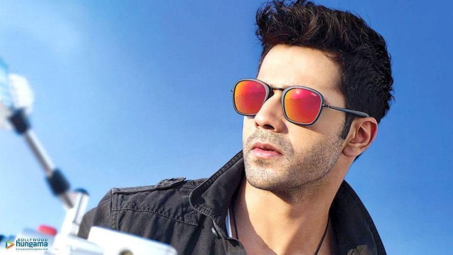 Varun Dhawan Wearing Reflective Sunglasses Against a Clear Blue Sky HD wallpaper
