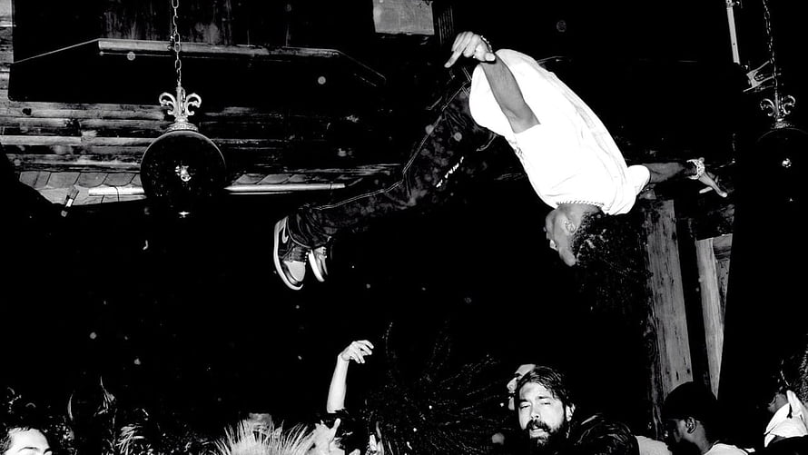 Black and white photo of a man crowd surfing at a concert with disco balls hanging from the ceiling, playboi carti HD wallpaper
