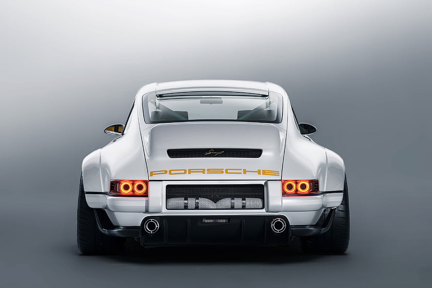 Rear View of White Porsche 911 Singer DLS Concept Car with Orange Lettering and Dual Exhausts HD wallpaper