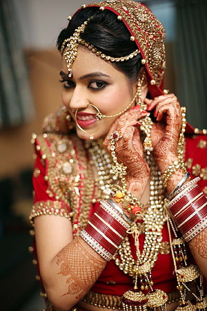 Elegant Indian Bride in Traditional Red Lehenga with Gold Jewelry and Intricate Henna HD phone wallpaper