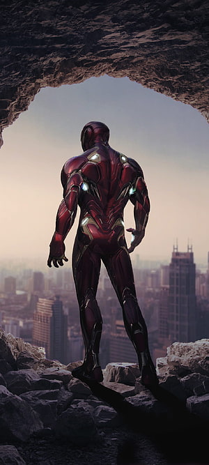 Iron Man Standing in Rocky Cave Overlooking City Skyline at Dusk, 1080x2400 Iron Man Cave 1080x2400 Resolution , 1080x2400 full mobile HD phone wallpaper