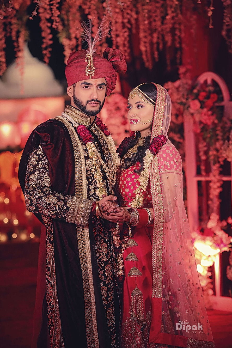 Traditional Indian Wedding Couple in Rich Red and Gold Attire HD phone wallpaper