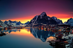 Reine Village at Sunset with Snow-Capped Mountains and Fjord Reflection in Norway HD wallpaper