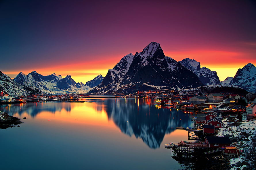 Reine Village at Sunset with Snow-Capped Mountains and Fjord Reflection in Norway HD wallpaper