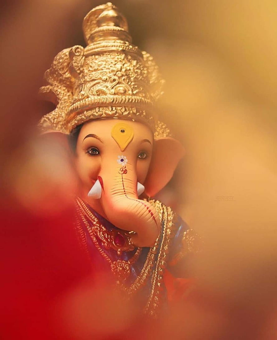 Close-up Portrait of Lord Ganesha with Golden Crown and Traditional Adornments HD phone wallpaper