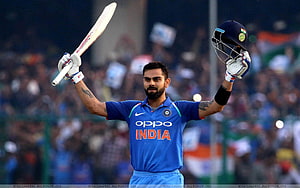 Virat Kohli Celebrating a Cricket Victory in Blue India Jersey HD wallpaper