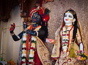 Radha Krishna Deities Playing Flute in Traditional Temple Setting HD wallpaper