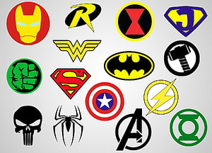Collection of iconic Marvel and DC superhero emblems and symbols on a light gray background HD wallpaper