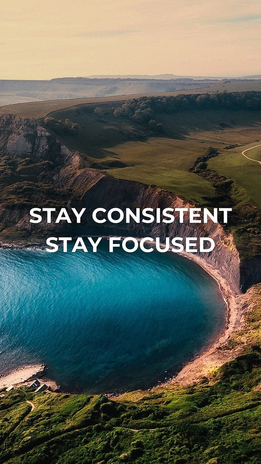 Aerial View of Turquoise Coastal Bay with Green Cliffs and Motivational Quote HD phone wallpaper