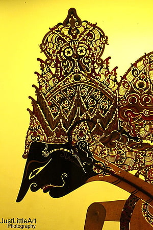 Intricate Wayang Kulit Shadow Puppet with Elaborate Carved Headdress and Ornate Patterns HD phone wallpaper