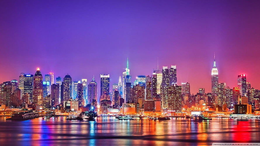 New York City Skyline at Night with Vibrant Purple Sky and Water Reflections HD wallpaper