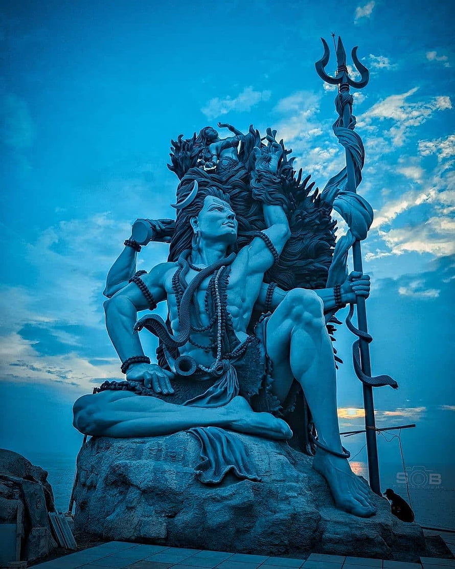 Majestic Shiva Statue at Azhimala Temple Under a Dramatic Blue Sky HD phone wallpaper