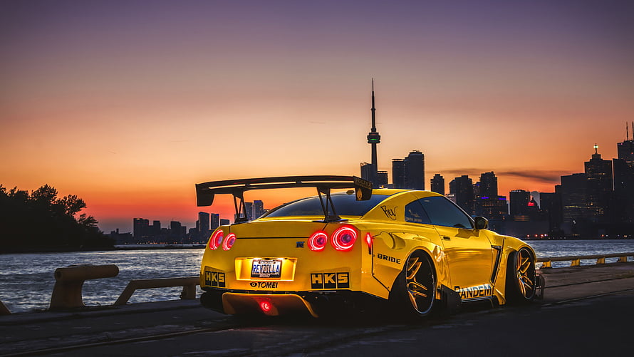 Yellow Nissan GT-R with HKS Widebody Kit Parked on Toronto Waterfront at Sunset HD wallpaper