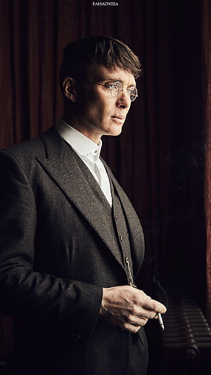 Thomas Shelby from Peaky Blinders in a dark suit smoking a cigarette HD phone wallpaper