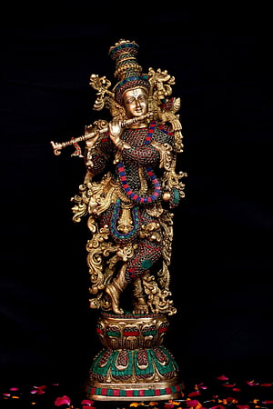 Ornate Krishna Statue with Flute and Peacock Crown on Decorative Pedestal HD phone wallpaper
