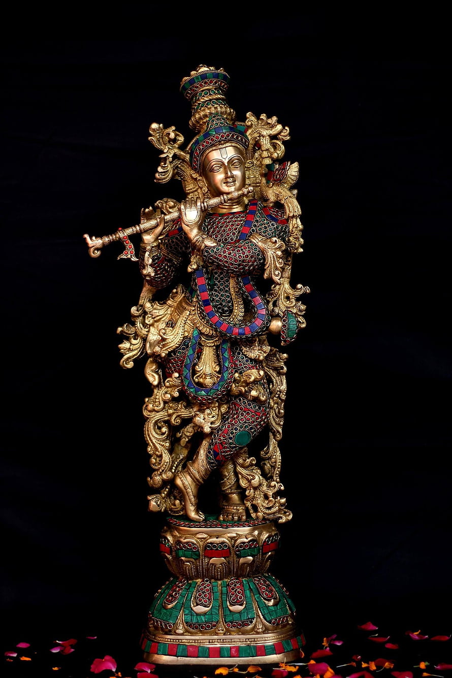 Ornate Krishna Statue with Flute and Peacock Crown on Decorative Pedestal HD phone wallpaper
