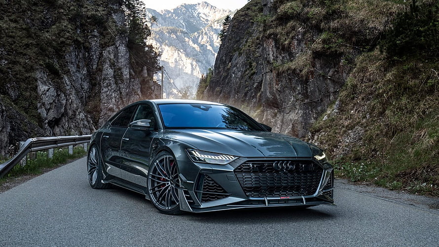 ABT Audi RS7 Sportback on a Mountain Road with Dramatic Rock Cliffs HD wallpaper
