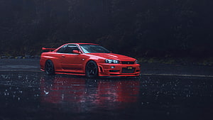 Red Nissan Skyline GT-R R34 on Wet Asphalt in Rainy Night Atmosphere HD wallpaper