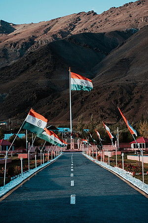 Patriotic Indian flags lining a road in the Himalayan mountains HD phone wallpaper