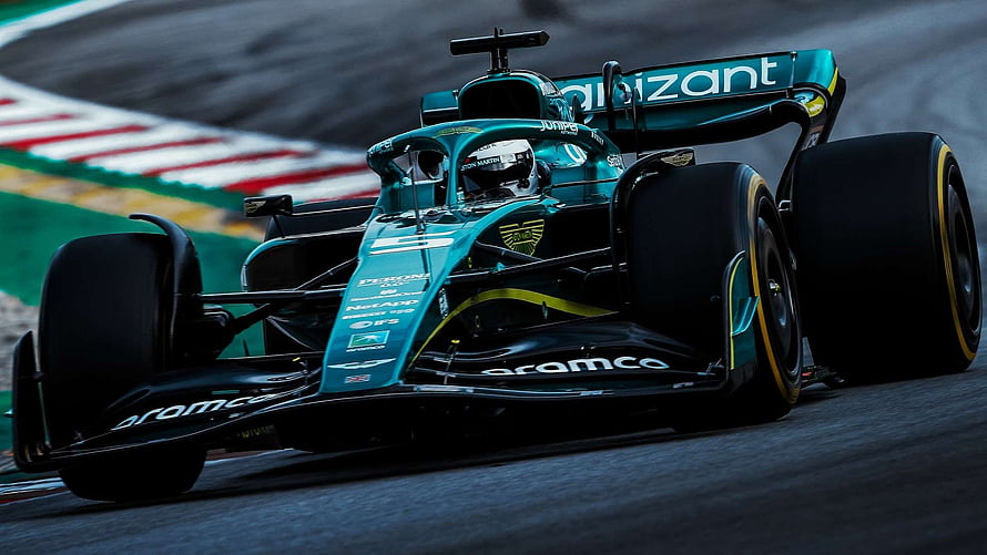 Aston Martin Formula 1 race car speeding on a wet track with Aramco livery HD wallpaper