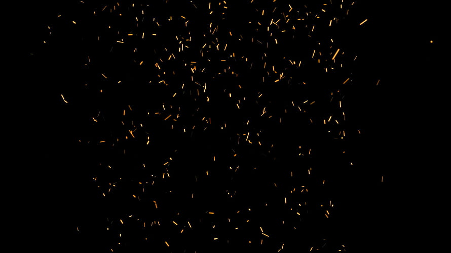 Glowing Fire Sparks Scattering Against a Deep Black Background HD wallpaper