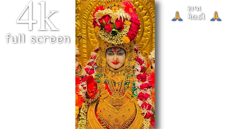 Goddess Durga adorned in gold jewelry and flowers for Durga Puja festival HD wallpaper