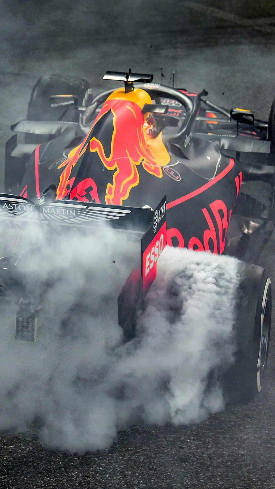 Red Bull Racing Formula 1 Car Performing a Burnout with Thick Tire Smoke HD phone wallpaper