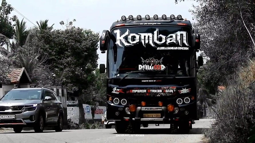 Komban Movie Black Tour Bus With Dawood Sticker Driving On Road HD wallpaper