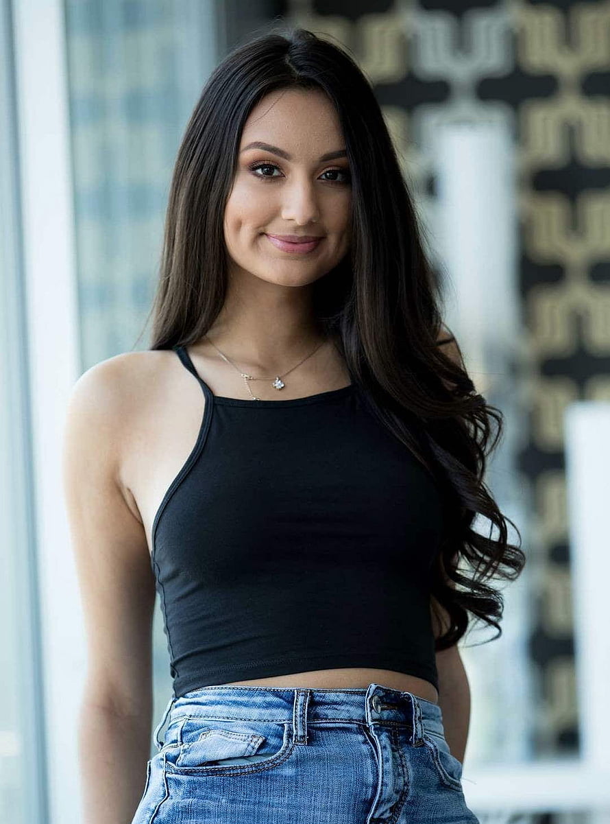 Eliza Ibarra in a black halter top and blue denim jeans with long dark hair HD phone wallpaper