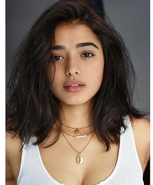 Ketika Sharma Portrait with Wavy Hair and Layered Gold Necklaces HD phone wallpaper