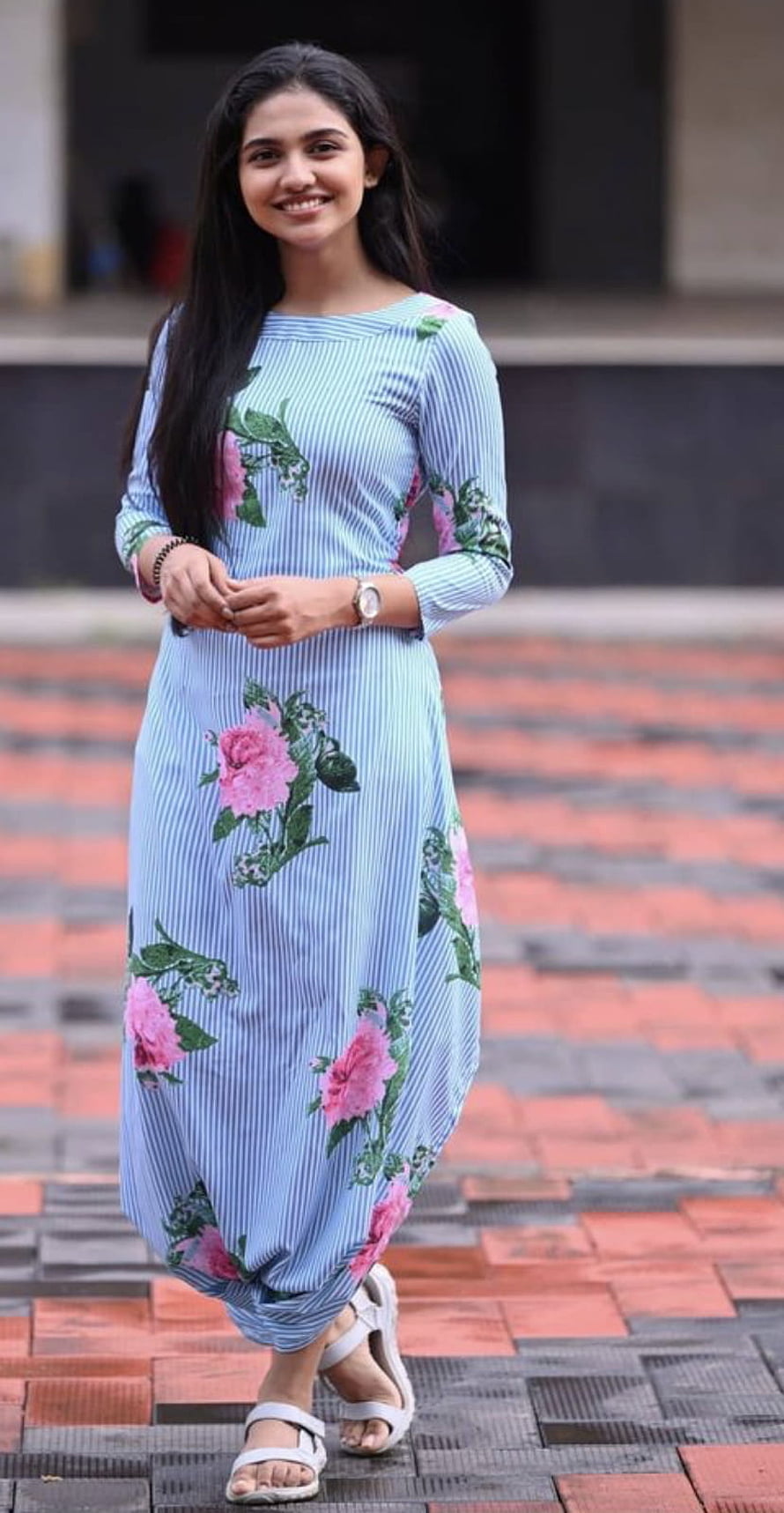 Mamitha Baiju in a Floral Blue Maxi Dress on a Brick Walkway HD phone wallpaper