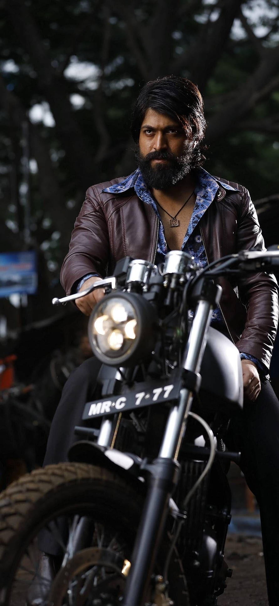 Allu Arjun as Pushpa Raj on a motorcycle in a leather jacket HD phone wallpaper
