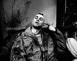 Black and white portrait of a man with a mohawk sitting on a couch holding a gun to his head, 103 Taxi Driver HD wallpaper