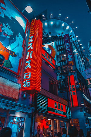 Neon-lit Tokyo street scene at night featuring Yoshinoya restaurant and vibrant anime billboards HD phone wallpaper
