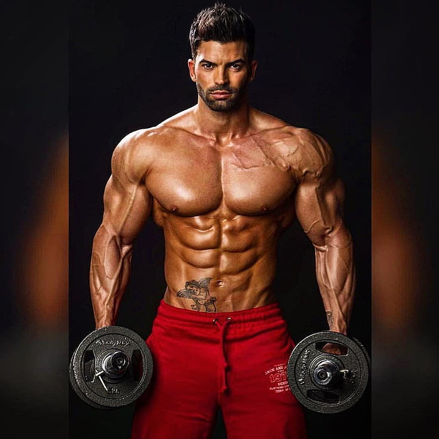 Sergi Constance Muscular Physique Portrait Holding Dumbbells in Red Sweatpants HD phone wallpaper