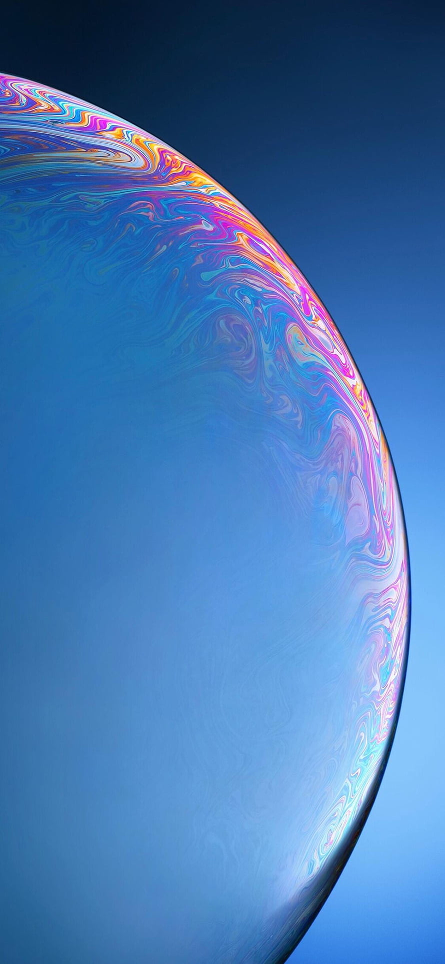 Iridescent Soap Bubble Close-Up with Rainbow Swirls on Blue Background HD phone wallpaper