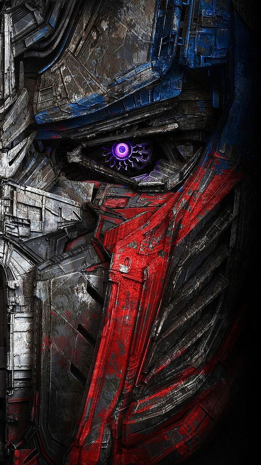 Close-up of Optimus Prime's face with glowing purple eye and battle-damaged armor HD phone wallpaper