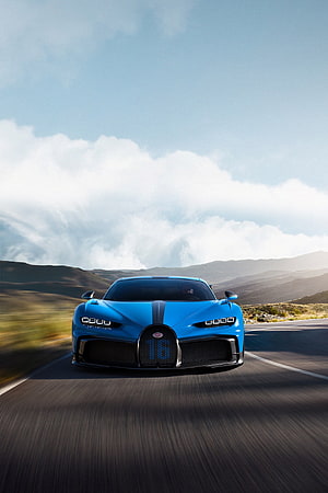 Blue Bugatti Centodieci Hypercar Driving on Scenic Mountain Road HD phone wallpaper