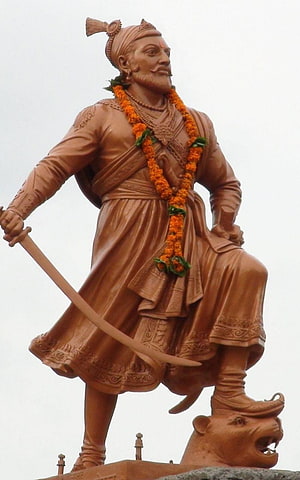 Bronze Statue of Chhatrapati Shivaji Maharaj Holding a Sword and Standing on a Tiger HD phone wallpaper