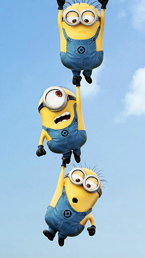 Three Minions Hanging in a Vertical Chain Against a Bright Blue Sky HD phone wallpaper