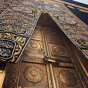 Ornate Golden Kaaba Door with Intricate Arabic Calligraphy and Islamic Geometric Patterns HD phone wallpaper