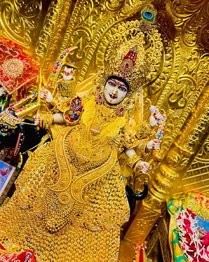 Ornate Golden Maa Malataj Deity Idol with Intricate Jewelry and Temple Backdrop HD phone wallpaper