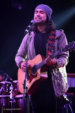 Jubin Nautiyal performing live on stage with acoustic guitar and microphone HD phone wallpaper