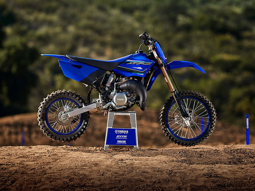 Blue Yamaha YZ250 dirt bike on a dirt track with forest background HD wallpaper