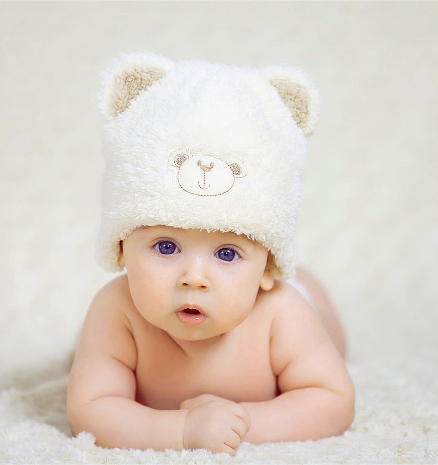 Adorable Baby Boy Wearing a Fluffy White Bear Hat Lying on a Soft Blanket HD phone wallpaper