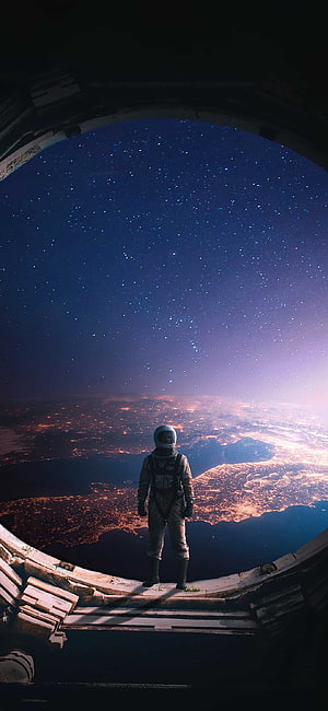 Astronaut Standing in Space Station Window Overlooking Earth at Night HD phone wallpaper