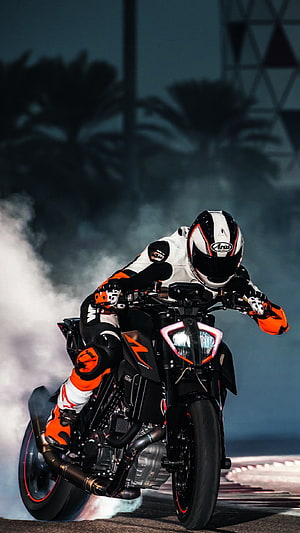 KTM RC 390 Motorcycle Drift Action Shot With Rider In White And Orange Gear HD phone wallpaper