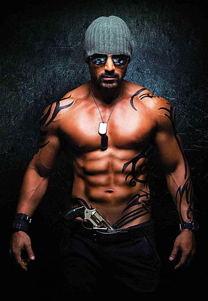 John Abraham shirtless portrait with tribal tattoos, beanie, sunglasses, and revolver HD phone wallpaper