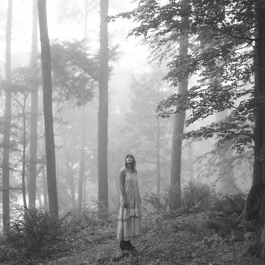 Taylor Swift in a misty forest wearing a flowing dress from the Folklore era HD phone wallpaper