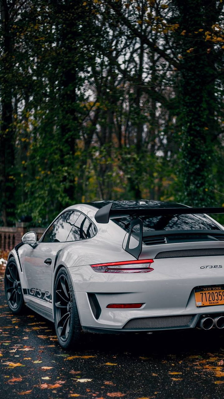 White Porsche 911 GT3 RS parked on a wet road surrounded by autumn trees HD phone wallpaper